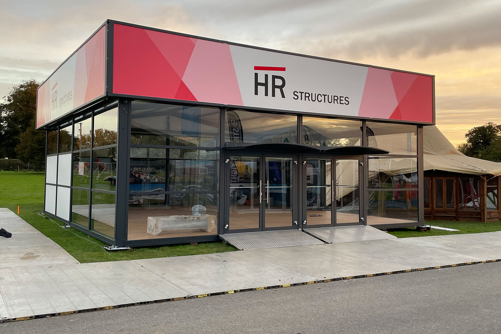 Marquee with glass front and flat roof construction