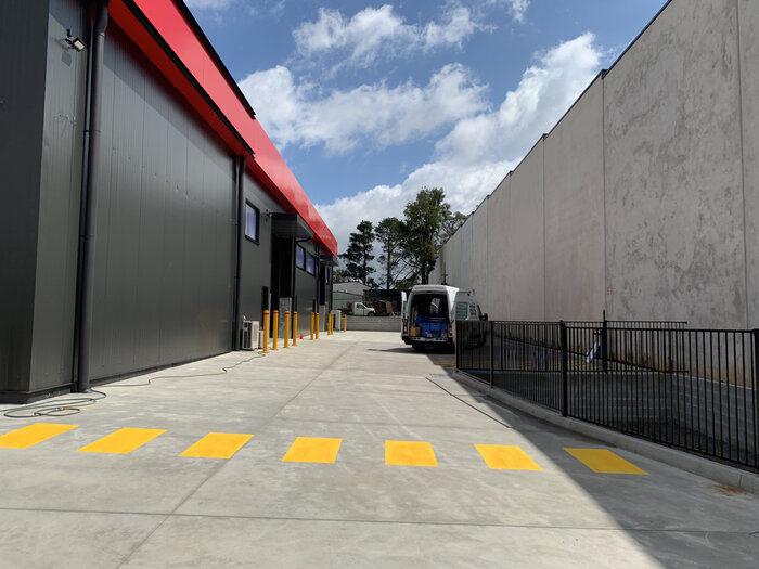 Exterior view of a warehouse with wide driveway