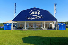 Polygon tent exterior view with advertising tarpaulin