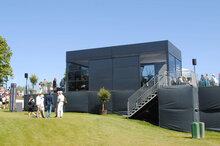 A black pagoda tent with glass elements