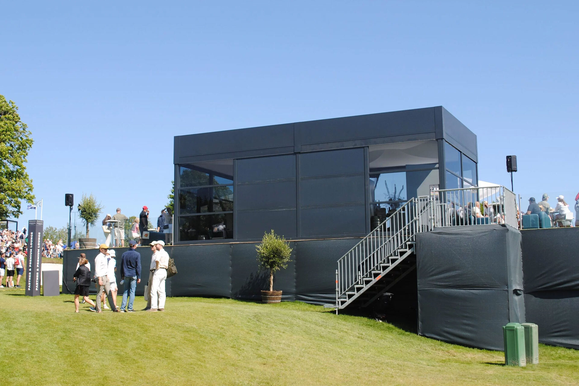 A black pagoda tent with glass elements