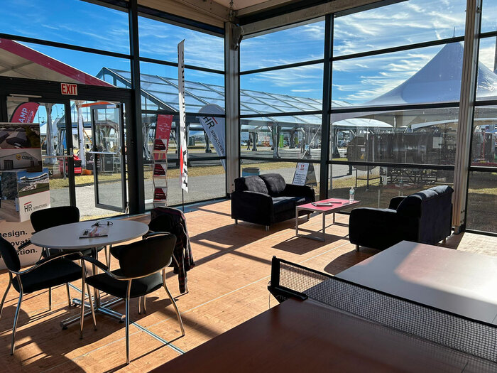 Interior view of the Skyline marquee from HR Structures with lounge area and glass façade