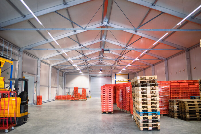 Insulated warehouse interior with roller door and plastic storage crates