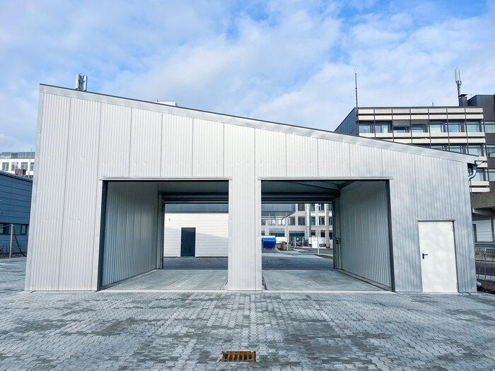 Front view of industrial cargo hall with two gate openings and side door