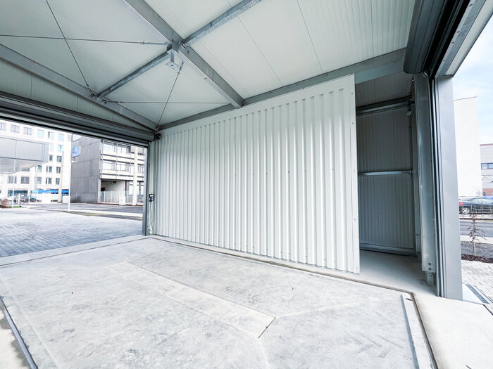 Interior view of cargo hall with open roller shutter door